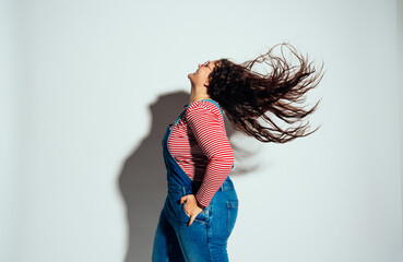 Plus size woman model posing in studio and having fun.