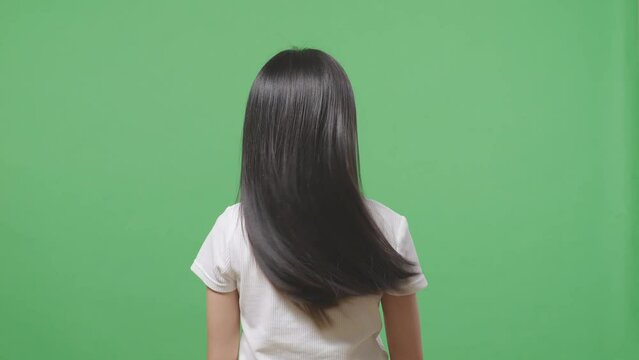 Back View Of A Woman Shaking Her Head Showing Her Long Black And Blond Straight Healthy Hair In The Green Screen Background Studio
