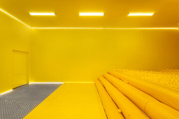 plain yellow room with a dry pool of yellow balls