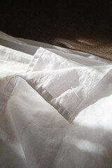 Top view of sheets and pillows. White linens. Bed texture