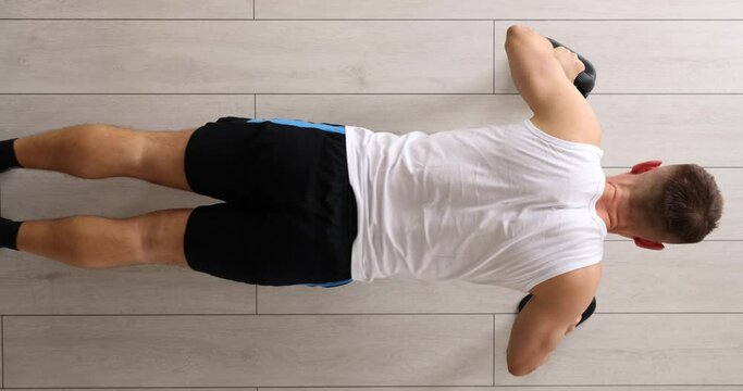 Man doing push ups from floor at sports training top view 4k movie. Home fitness concept