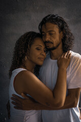 romantic couple of lovers with black background playing and caressing