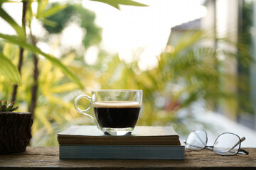 coffee glass cup glasses and tea cup and notebooks and cactus pot on wooden table