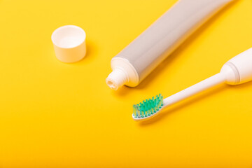 Sonic electric toothbrush, toothpaste, mouthwash, dental floss and tongue cleaner on yellow background. Oral hygiene. Dental care.Dentistry concept.Place for text.Place for copy.