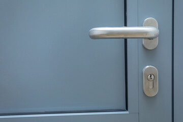Metal handle and aluminum door with lock insert.
