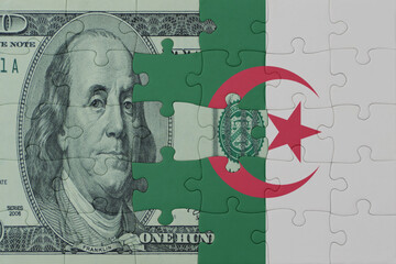 puzzle with the national flag of algeria and dollar money banknote. macro.concept.