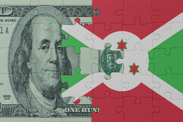 puzzle with the national flag of burundi and dollar money banknote. macro.concept.
