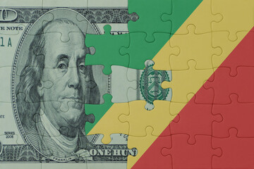 puzzle with the national flag of republic of the congo and dollar money banknote. macro.concept.