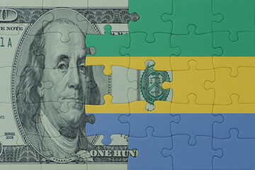 puzzle with the national flag of gabon and dollar money banknote. macro.concept.