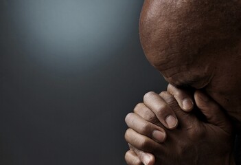 Fototapeta na wymiar man praying to god with hands together Caribbean man praying with black background with people stock photos stock photo