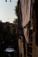 View on laundry is drying on buildings in old town in sunny day