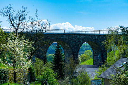 Historic stone railway viaduct on a sunny day against a blue sky