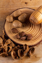 Fototapeta na wymiar Breaking almonds on a wood_03