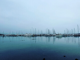 Sailboat reflections at Port Sidney Marina on a dreary dark and overcast day - Sidney, Vancouver Island, British Columbia, Canada