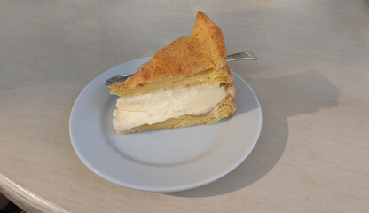 Cheesecake piece on tiny white plate. Morning coffee dessert. New York cheesecake pie.