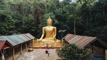 golden buddha statue  in the forest