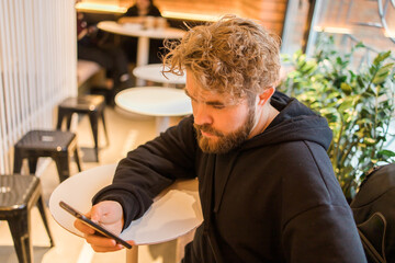 Social media and digital online concept - young man using smart phone with Social media. Living on vacation and playing social media concept