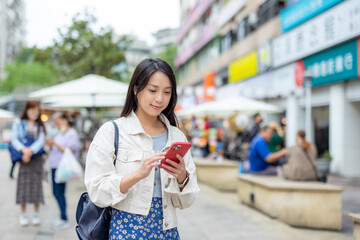 Woman use smart phone in the street