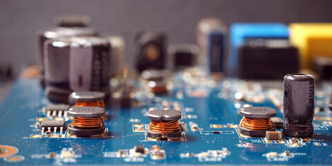 Close up of coils on industrial circuit board. Electronic components background.