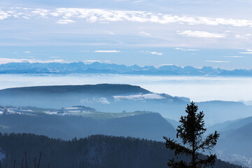 Mountain view with the Alps at the background in a foggy autumn day in Wasserfallen, Baselland, Switzerland