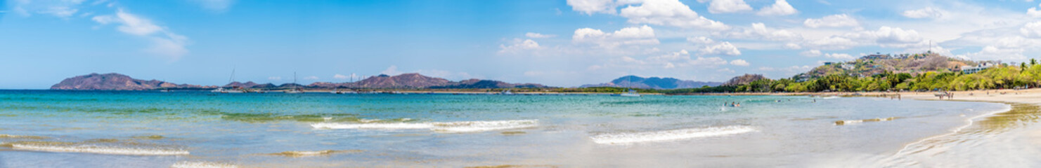 A panorama view across the beach and bay at Tamarindo in Costa Rica in the dry season