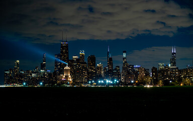 Obraz na płótnie Canvas Chicago Skyline at Night with Searchlight