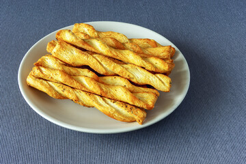 Butter dough sticks in a plate on a table tablecloth