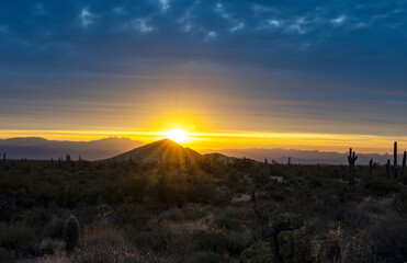 A Rising Sun With Sun Rays In The Arizona Desert