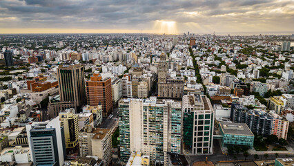 Fototapeta na wymiar aerial of Montevideo city of Uruguay , with Palacio Salvo at the intersection of 18 de Julio Avenue and Plaza Independencia dramatic sunset