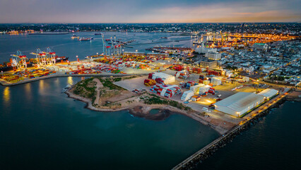 Aerial of Montevideo capital city of Uruguay illuminated at night cargo ship on commercial port harbor