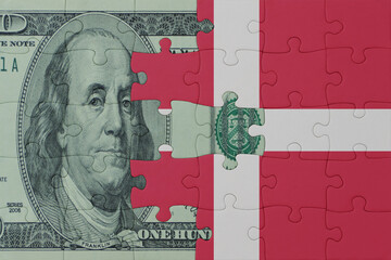puzzle with the national flag of denmark and dollar money banknote. macro.concept.