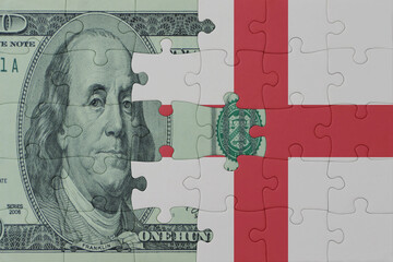 Fototapeta premium puzzle with the national flag of england and dollar money banknote. macro.concept.