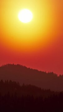 Big sun close-up, sunset behind the mountains Beautiful nature video time lapse landscape.Vertical