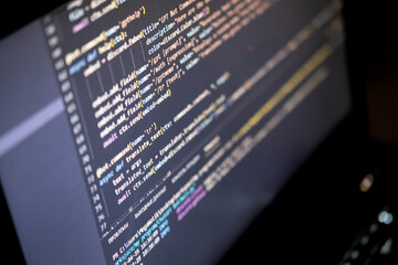 Software source code. Program code. Code on a computer screen. The developer is working on program codes in the office. Photo with source code.