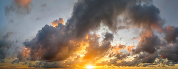 Colofrul clouds brightly illuninated by setting sun on evening sky. Changing cloudscape weather at sunset