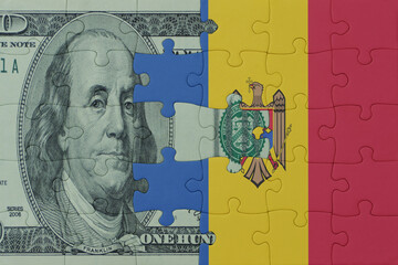 puzzle with the national flag of moldova and dollar money banknote. macro.concept.