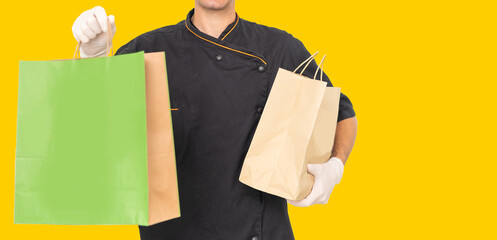 Young handsome man holding delivery paper bag