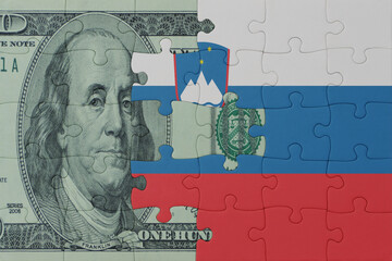 puzzle with the national flag of slovenia and dollar money banknote. macro.concept.