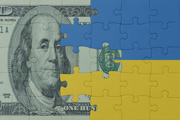 puzzle with the national flag of ukraine and dollar money banknote. macro.concept.