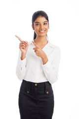 Happy young business woman pointing isolated on white.
