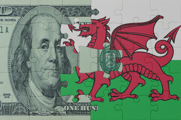 puzzle with the national flag of wales and dollar money banknote. macro.concept.