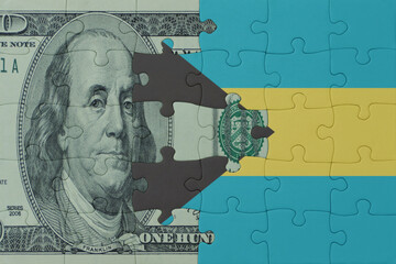 puzzle with the national flag of bahamas and dollar money banknote. macro.concept.