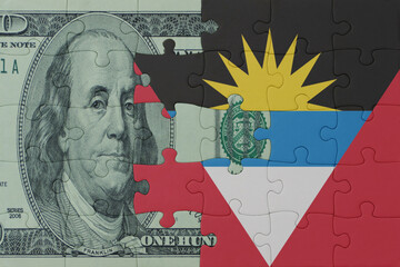 puzzle with the national flag of antigua and barbuda and dollar money banknote. macro.concept.
