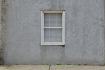 Wood framed window gray stucco wall background