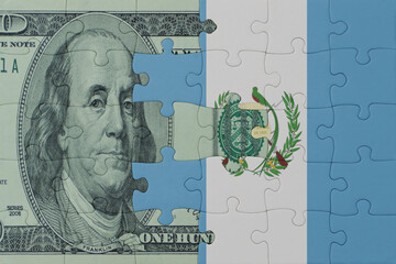 puzzle with the national flag of guatemala and dollar money banknote. macro.concept.