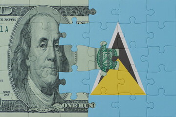 puzzle with the national flag of saint lucia and dollar money banknote. macro.concept.