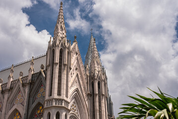 Exterior facade of a neo gothic church with and cloudy sky in background