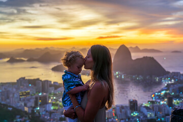 Mother and son tourists at the Dona Marta lookout overlooking the Sugar Loaf Mountain
