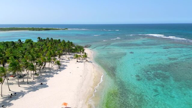 Aerial view of amazing tropical beach with white sand palm trees and turquoise water on a paradise island. Excursion to the Morrocoy National Park, Venezuela