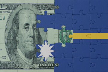 puzzle with the national flag of Nauru and dollar money banknote. macro.concept.